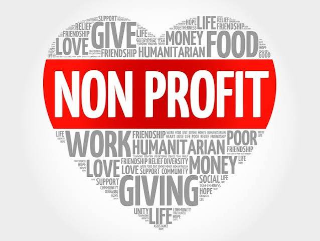 Heart-shaped word cloud with non-profit themes including give, community, volunteering, and humanitarian