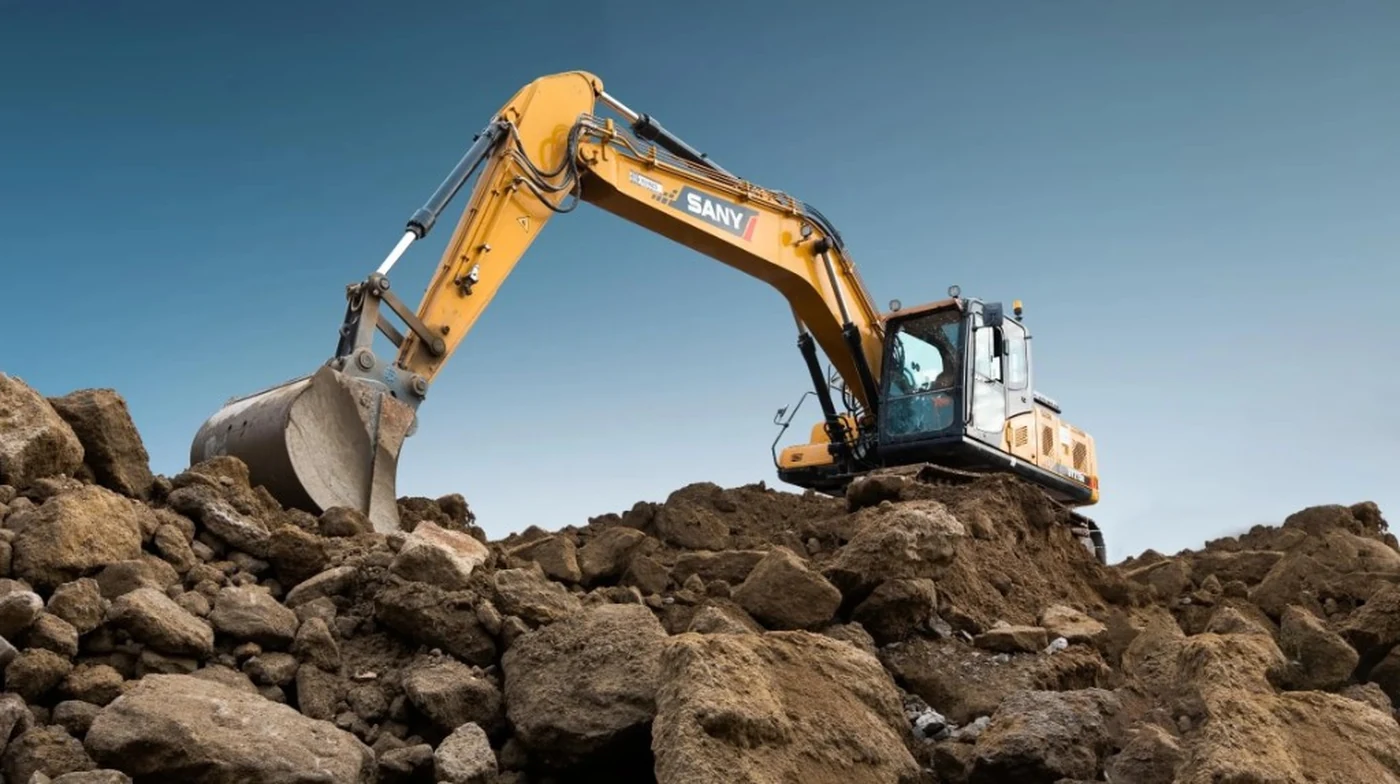 Yellow excavator working on a rocky construction site